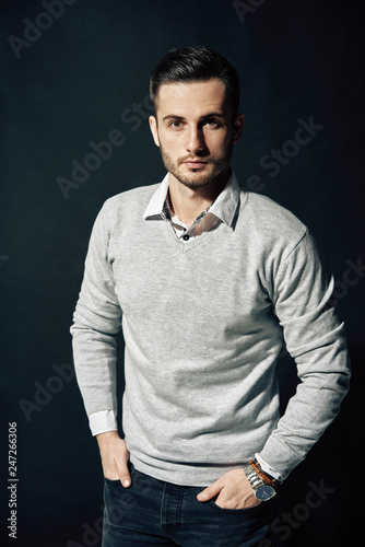 Stylish handsome man portrait on dark background