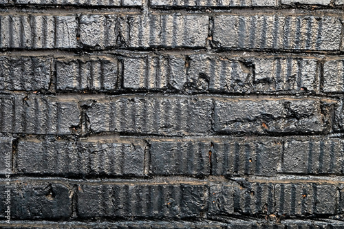 Black brick wall in vintage style on dark background. Rough brick wall texture brick background dark black. Black brick wall background. Vintage brick texture. Home interior decor.