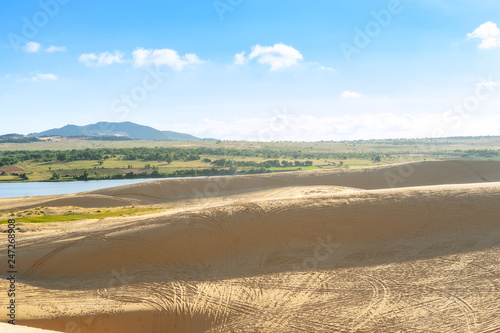 Landscape view of sand dunes with car trail at White Sand Dunes  Mui Ne  Vietnam.