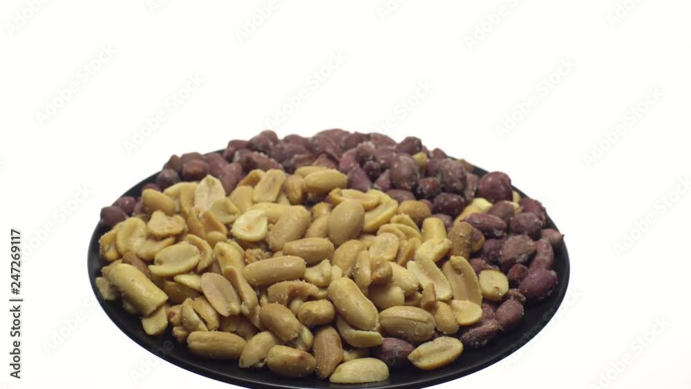 Peanuts. Mixed Peanuts in rotation. Snack closeup. Peanuts in a bowl. Selective focus. Isolated on white. Studio shot. Healthy food concept. Peanuts. Mixed Peanuts in rotation. Snack closeup. Peanuts in a bowl. Selective focus. Isolated on white. Studio shot. Healthy food concept.