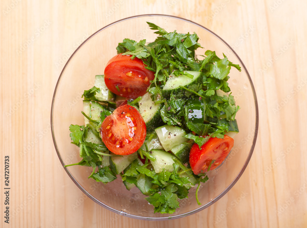 salad in transparency glass bowl on wooden table salad in transparency glass bowl on wooden table