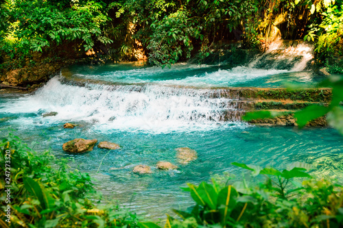 Fototapeta Naklejka Na Ścianę i Meble -  Kawasan waterfall in a mountain gorge in the tropical jungle of the Philippines, Cebu.