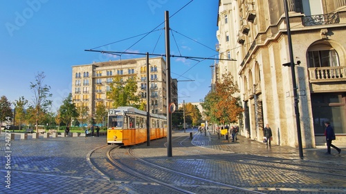 Yellow rail tram of the city of Budapest in Hungary. Tram line number 2. voted the best scenic european route by the National Geographic. Blurred unrecognizable faces of people.