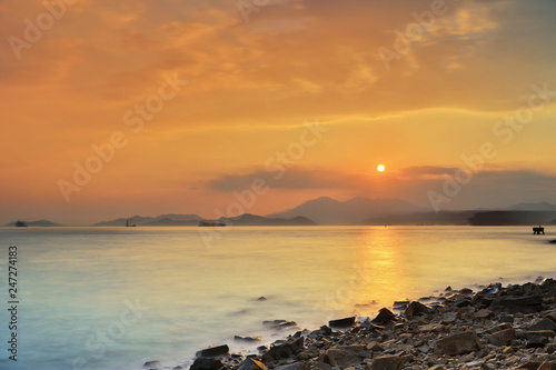 Stone with wave at sandy bay photo