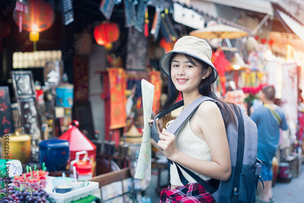 Woman traveling backpack,Asian traveler standing and walking in china town