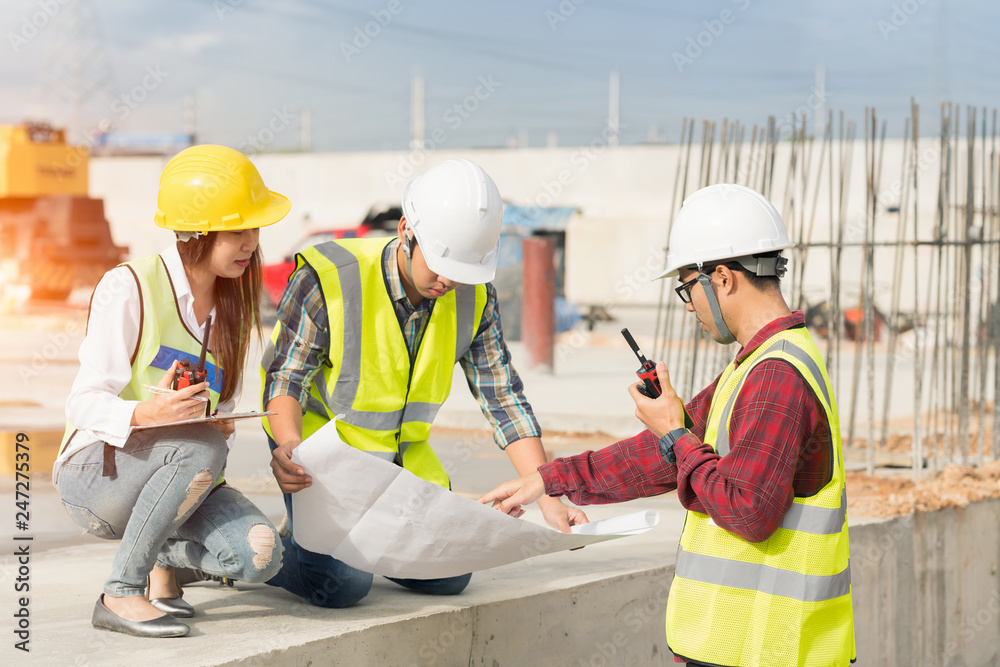 Civil engineers at construction site and a land surveyor using an altometer Civil engineers at construction site and a land surveyor using an altometer