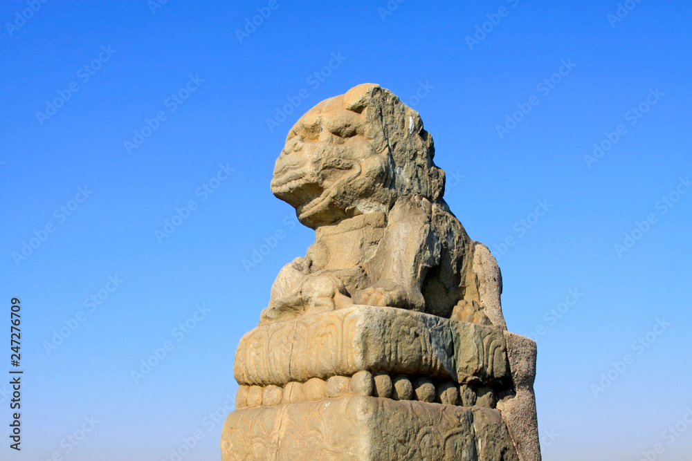 stone lion on bridge railing, China