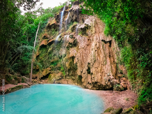 Tumalog waterfall in a mountain gorge in the tropical jungle of the Philippines, Cebu.