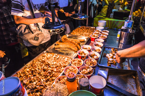 This snack food is a squid which is deep fried till golden brown and extremely crispy. The squid is lightly coated with salt and pepper at the Raohe night market, Taiwan.
