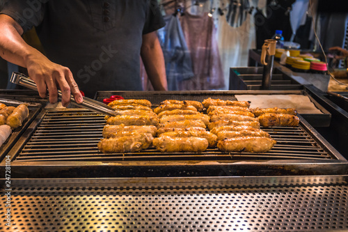 The most common Taiwanese street food in Raohe night market is the sausage and bratwurst.  photo