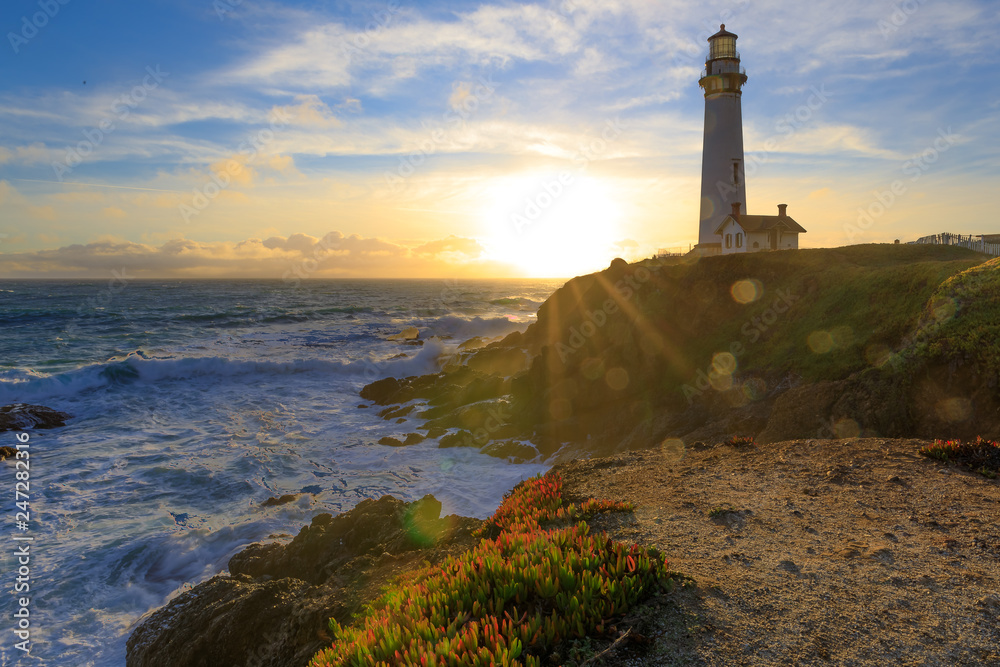 Pigeon Point Lighthouse on Northern California Pacific Ocean coastline just before sunset with an artistic sun flare, vintage look