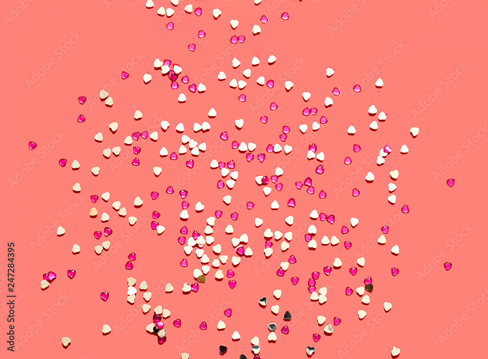 Festive coral background with spangles in the shape of heart. Concept Valentines Day or Mothers Day.
Festive coral background with spangles in the shape of heart. Concept Valentines Day or Mothers Day.