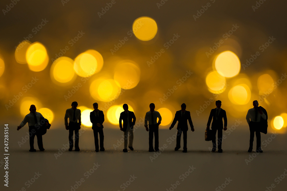 Miniature people : Businessman team Silhouette with Abstract lighting Bokeh defocused background