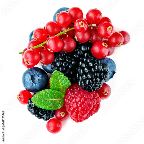 Berries mix isolated on white background. Mixed Pile of Raspberry, Red currant,  Blueberry and Blackberry with mint leaves. Top view