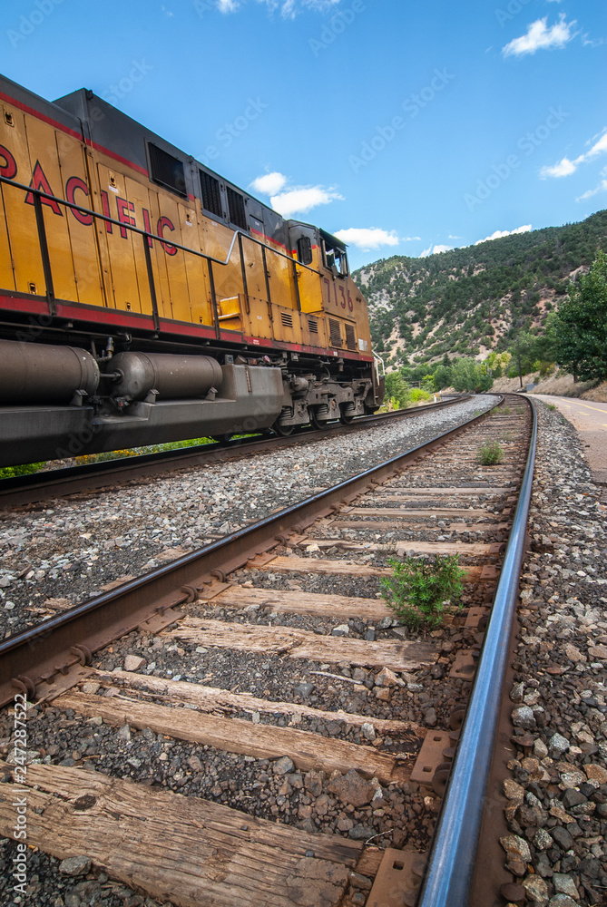 Train next to empty train tracks in glenwood springs taken with wide angle lens.