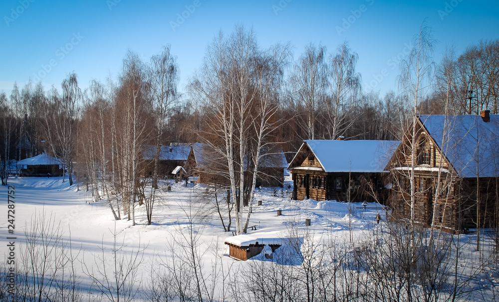 Winter landscape with a huts