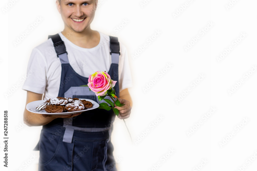 A young man builder congratulates you with something on a white background. Blur