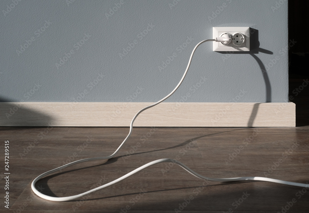 Power cord cable plugged into wall outlet Power cord cable plugged into wall outlet