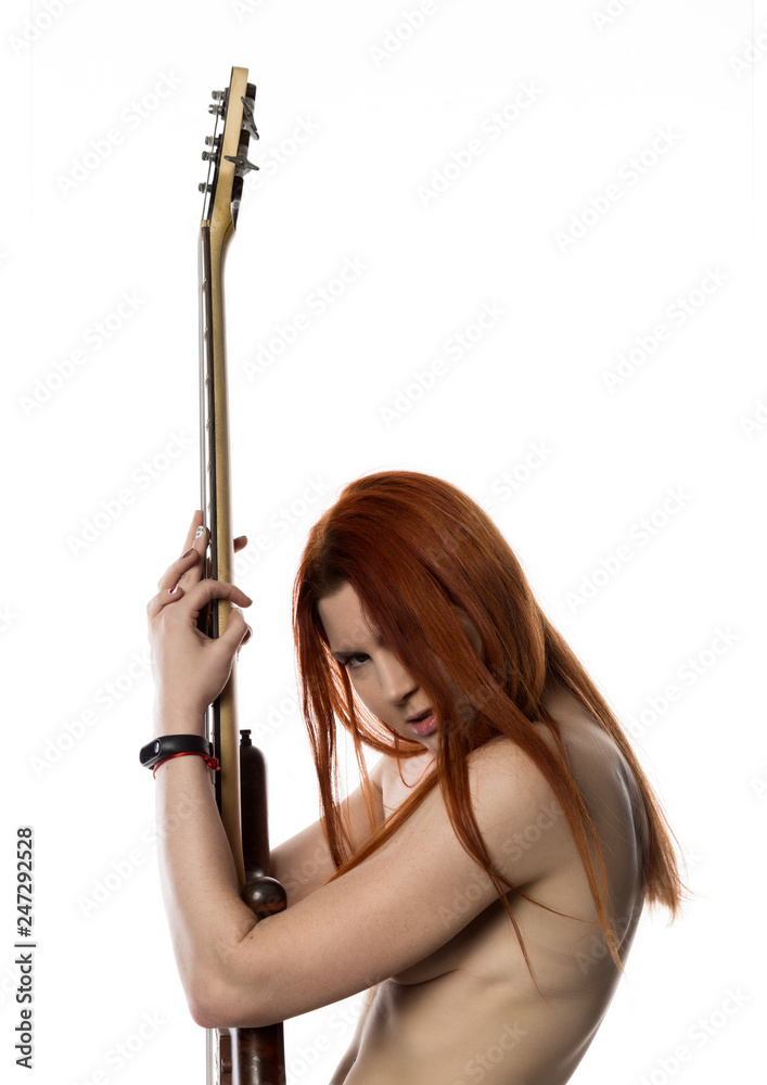 sexy redhead woman holding electric guitar on a white background. rock girl playing on a guitar.