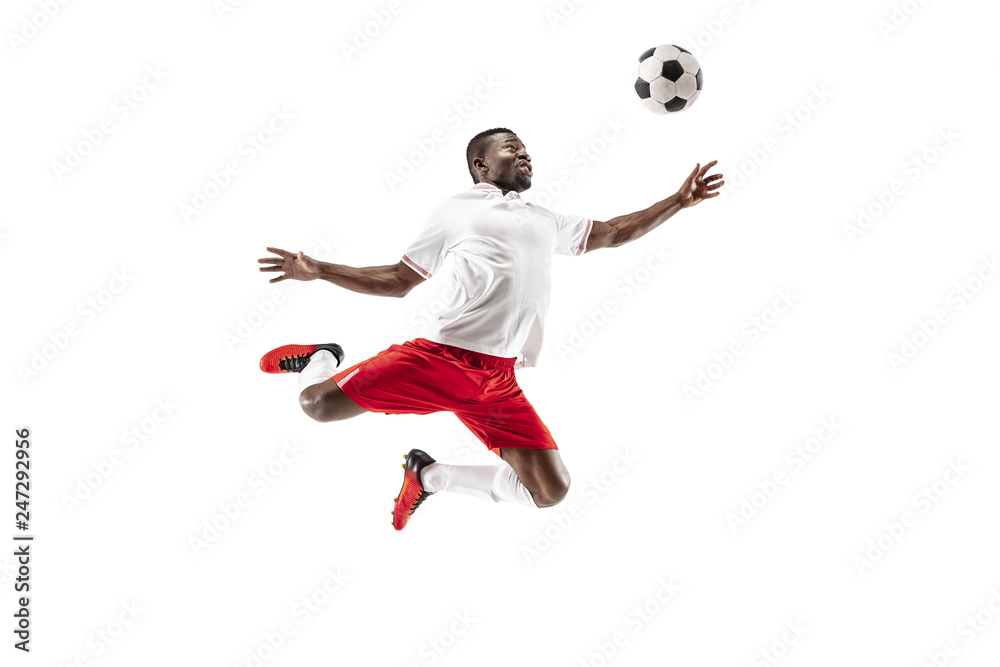 Professional african american football soccer player in motion isolated on white studio background. Fit jumping man in action, jump, movement at game.