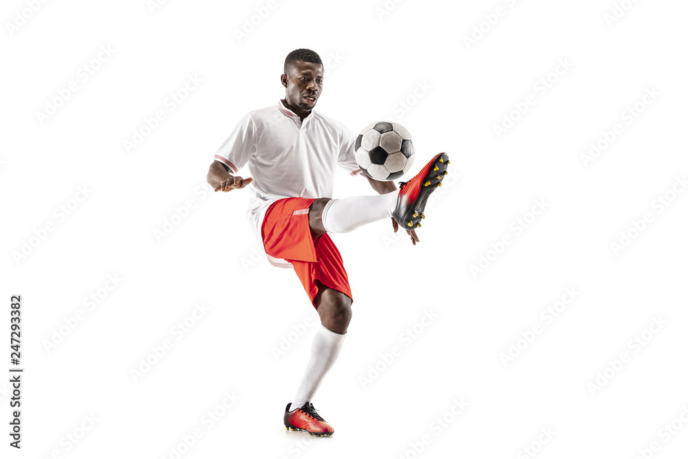 Naklejka premium Professional african american football soccer player in motion isolated on white studio background. Fit jumping man in action, jump, movement at game.