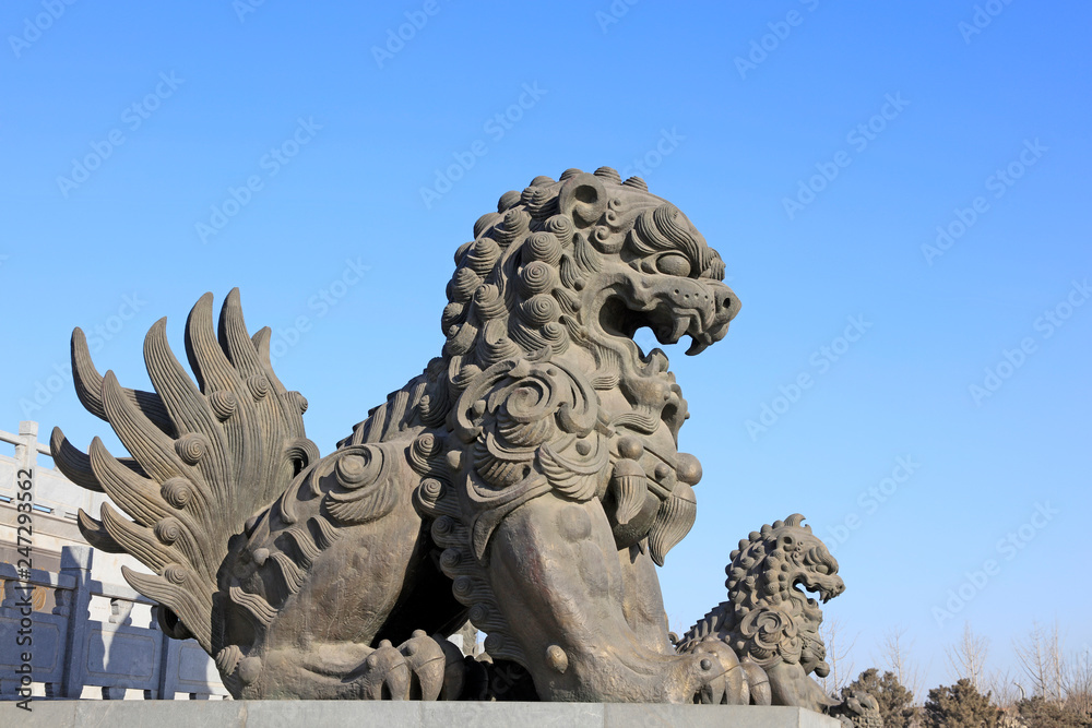 Fototapeta premium giant lion sculptures under blue sky, tangshan city, China