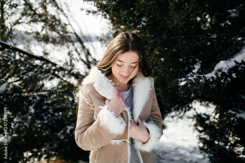 Young Beautiful girl Smiling and posing Outdoors in Snowy Winter