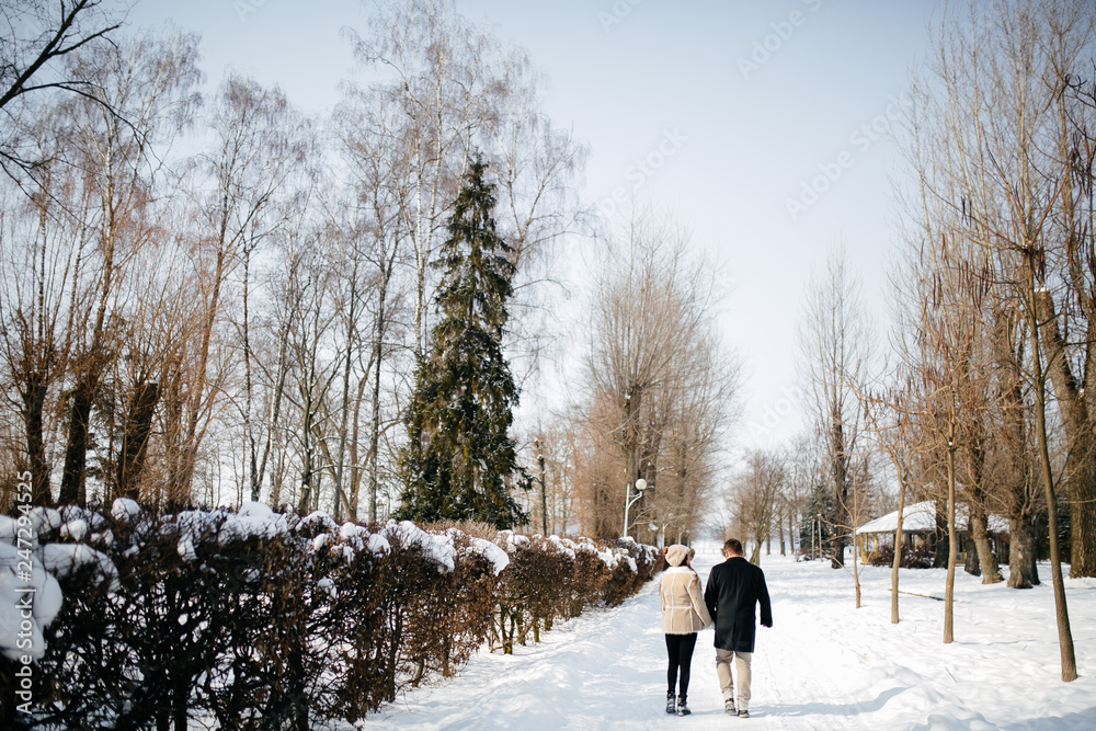 Young Beautiful Couple Taking Fun and Smiling Outdoors in Snowy Winter Young Beautiful Couple Taking Fun and Smiling Outdoors in Snowy Winter