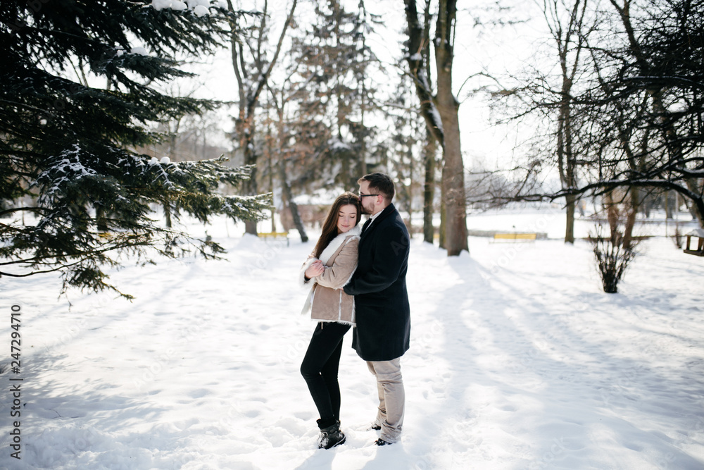 Young Beautiful Couple Taking Fun and Smiling Outdoors in Snowy Winter Young Beautiful Couple Taking Fun and Smiling Outdoors in Snowy Winter