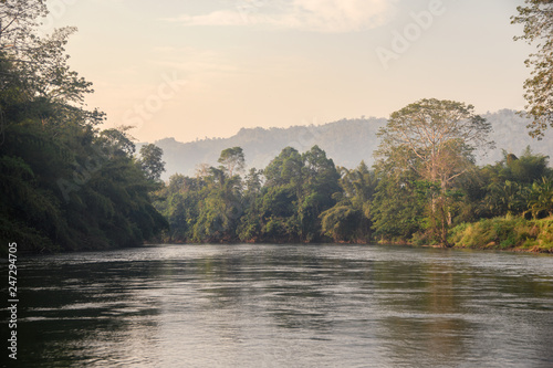 Sailing boat sightseeing of tropical jungle in river kwai