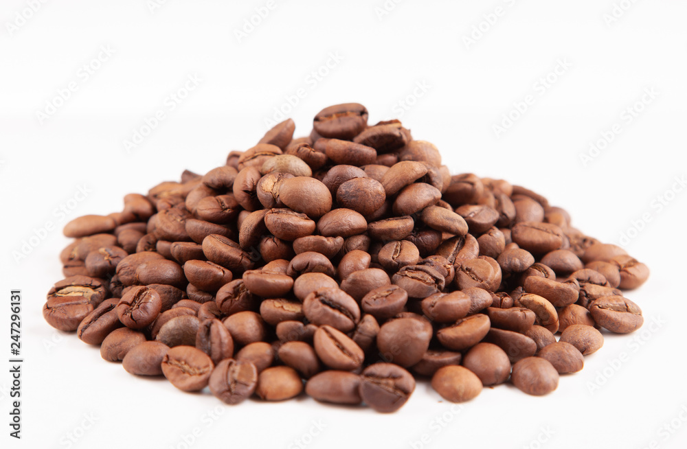 Textured brown coffee beans on a white background. Textured brown coffee beans on a white background.