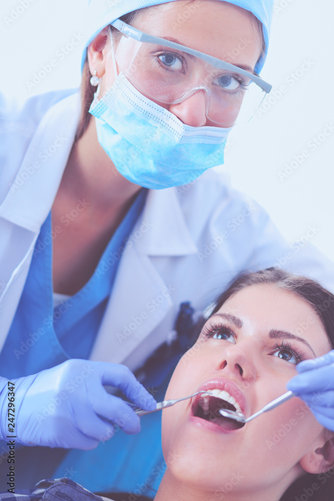 Woman dentist working at her patients teeth . Woman dentist Woman dentist working at her patients teeth . Woman dentist