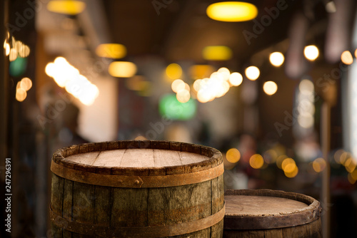 Beer barrel with beer glasses on a wooden table. The dark brown background. © kishivan