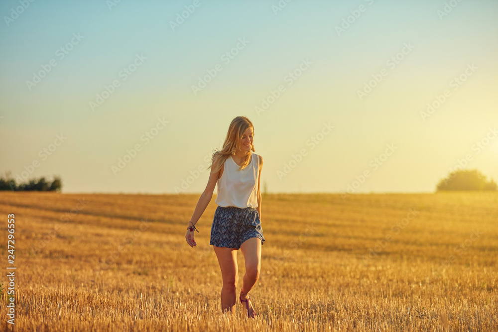 Cute young woman jumping in a wheat field. Cute young woman jumping in a wheat field.