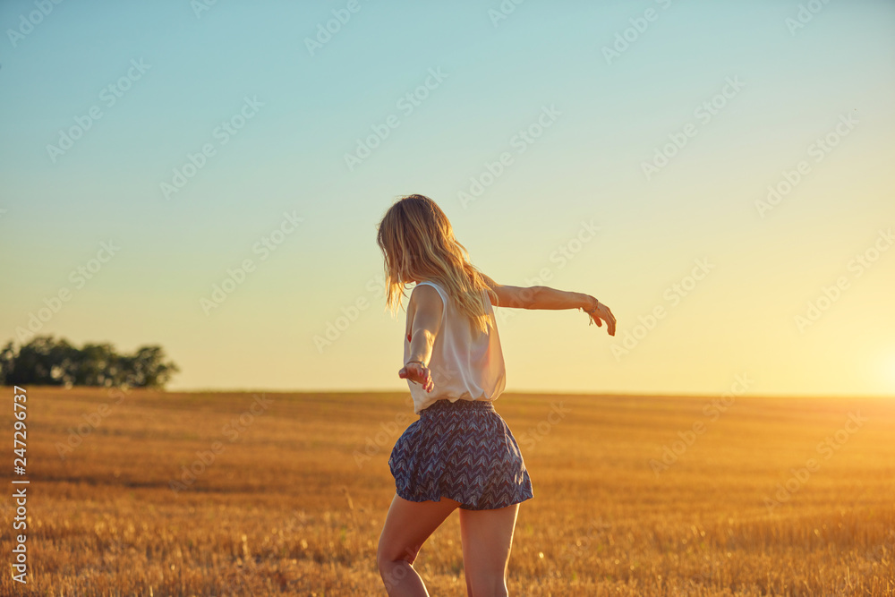 Cute young woman jumping in a wheat field. Cute young woman jumping in a wheat field.