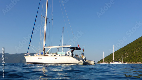 Yachts and sailboats anchored off the coast of Kefalonia island, Antisamos beach, Ionian sea, Greece.