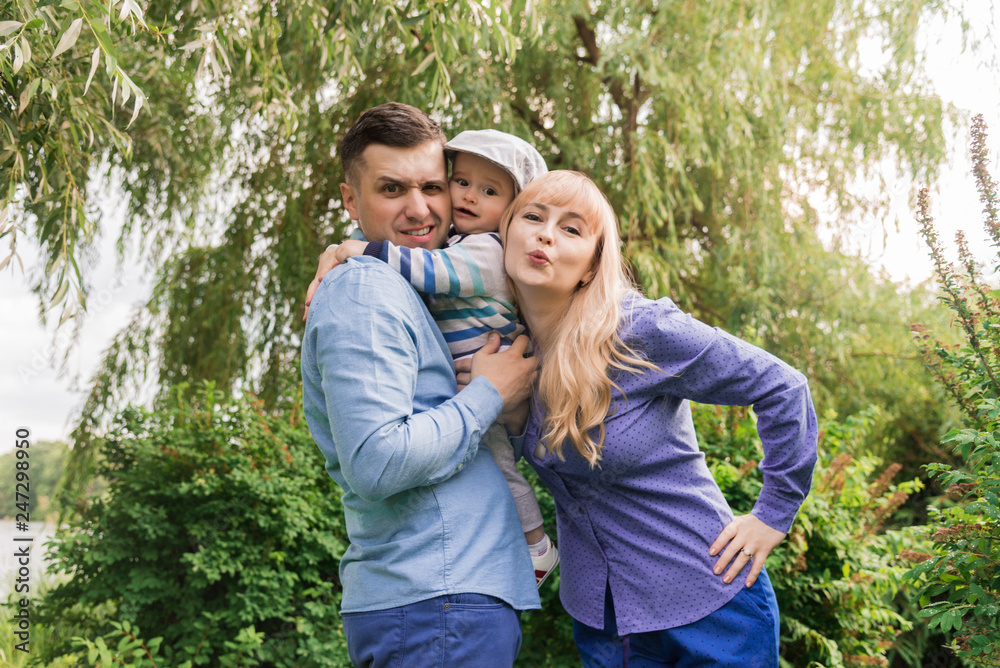 Family walk in the park. Family walks in the park. Man, woman and child in nature.