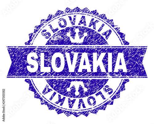 SLOVAKIA rosette stamp watermark with distress style. Designed with round rosette, ribbon and small crowns. Blue vector rubber watermark of SLOVAKIA text with dirty style.