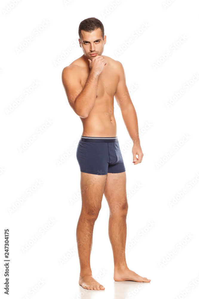 Shirtless handsome man in panties on white background Shirtless handsome man in panties on white background