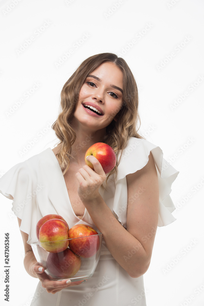 attractive smiling young woman holding red apples. white background attractive smiling young woman holding red apples. white background