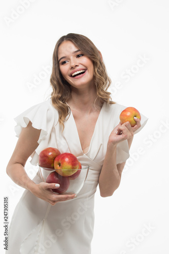 attractive smiling  young woman holding red apples. white background