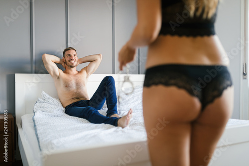 Woman and man playing domination games in bed