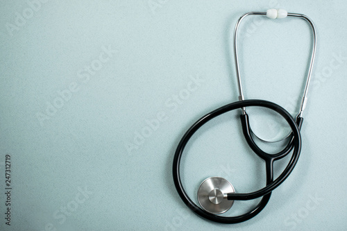 Medical background with with statoscope and pills. Сoncept pharmacy, clinic, drugs, headache medicine. Image on illness, cardiology, treatment