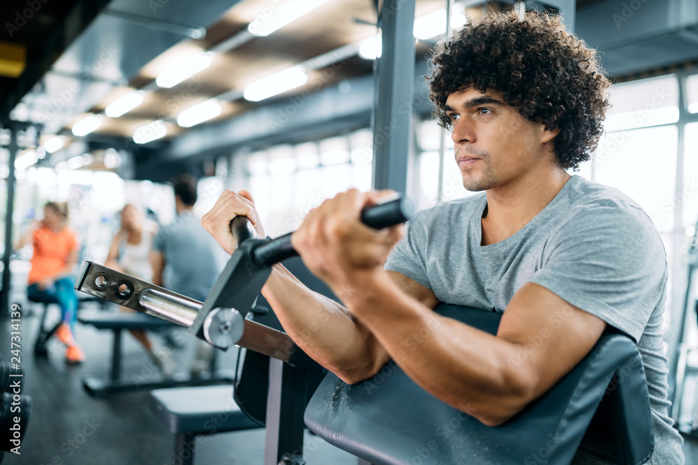 Determined male working out in modern gym Determined male working out in modern gym