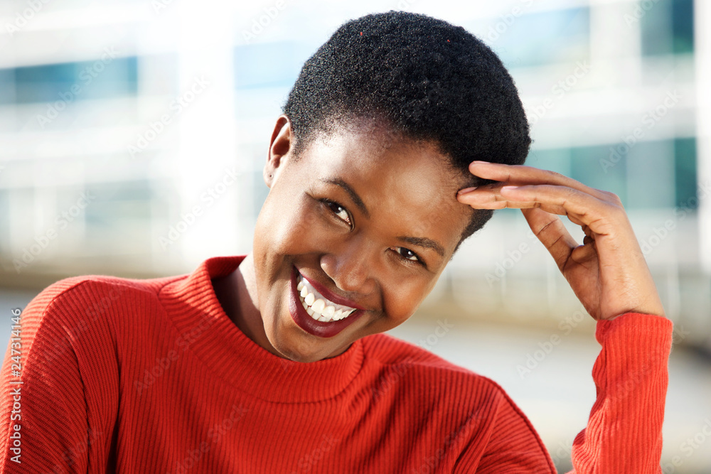 Close up beautiful young african woman smiling outside Close up beautiful young african woman smiling outside