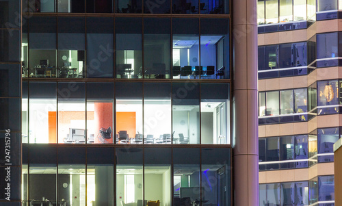 Privacy of individual apartment units with lit windows at night.