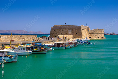 Fototapeta Naklejka Na Ścianę i Meble -  Fishing boats and Venetian Fortress in Heraklion, Crete, Greece