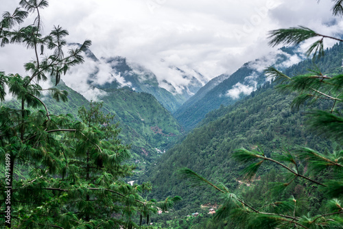 Tropical mountain range view. Timelapse Of Moving Clouds And Fog over Himalayan mountain range in Sainj