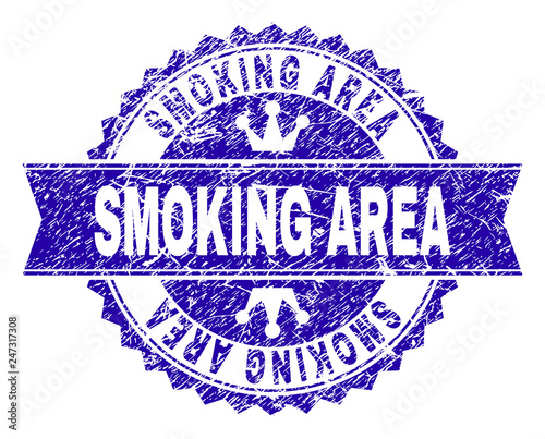 SMOKING AREA rosette seal overlay with grunge texture. Designed with round rosette, ribbon and small crowns. Blue vector rubber print of SMOKING AREA title with grunge texture.