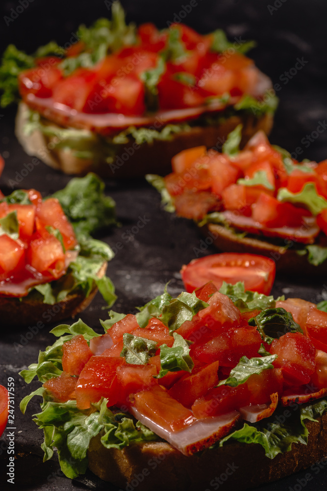 Italian tomato bruschetta with chopped vegetables, herbs and oil on grilled or toasted crusty ciabatta bread Italian tomato bruschetta with chopped vegetables, herbs and oil on grilled or toasted crusty ciabatta bread